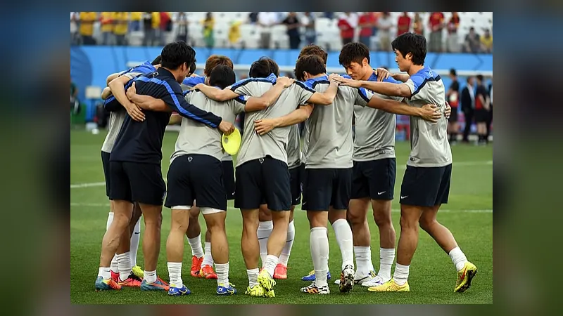 A football team standing in a huddle with arms around each other